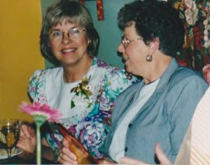 sandy and emily with flowers and wine